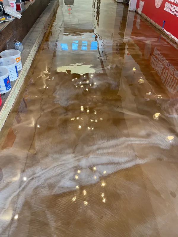 Metallic epoxy floor coating catching light in Michigan garage
